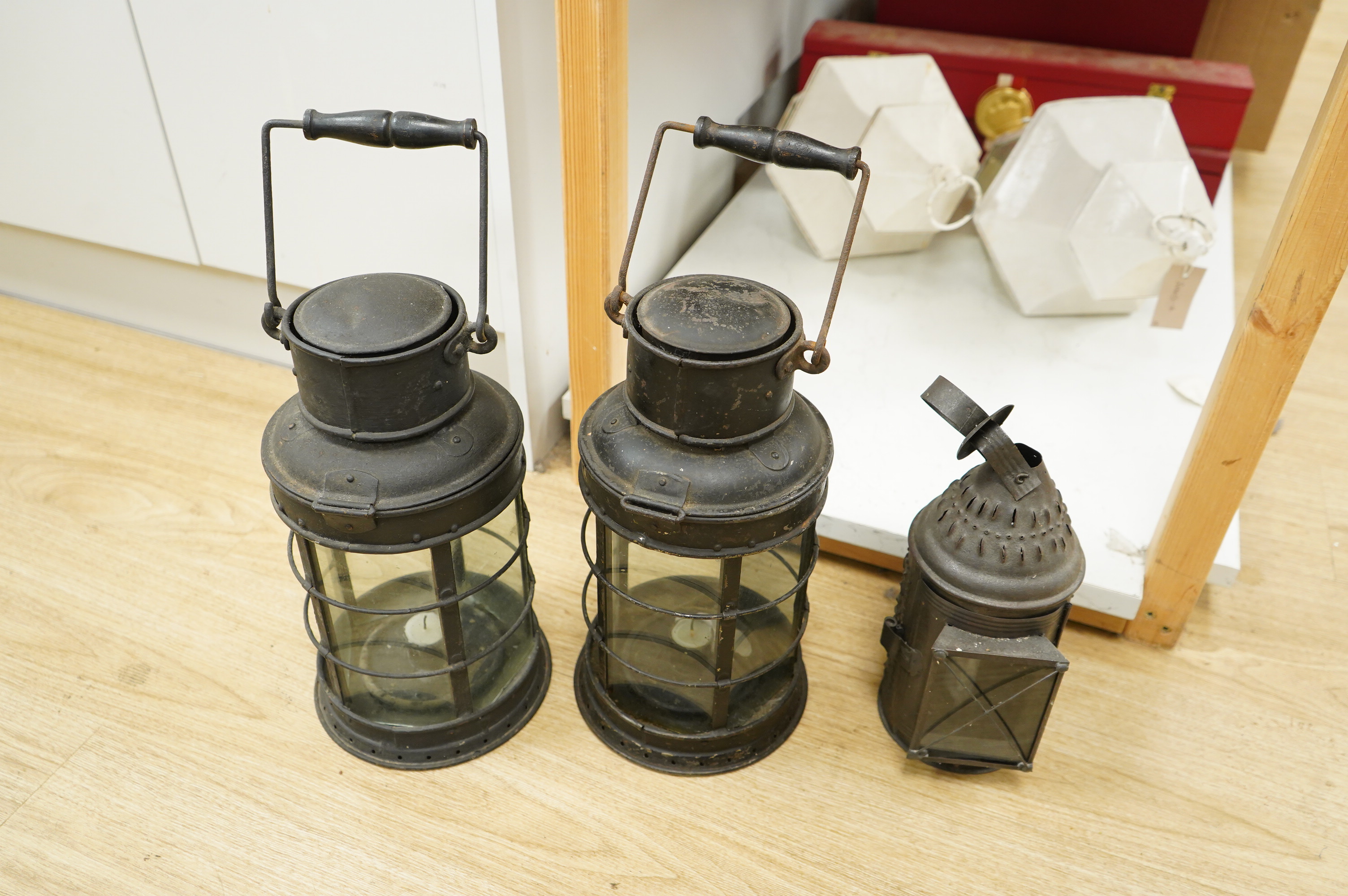 A pair of early 20th century railway hanging lanterns and one other, largest each 45cm high including swing handle